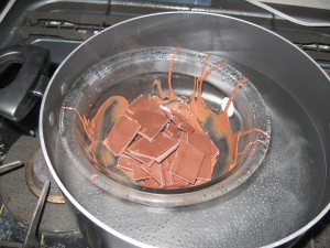 A glass bowl in hot water is a good way to melt chocolate if you can't get a 