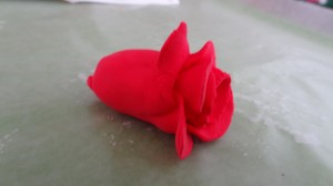 A red clay rose close up tp show the individual petals